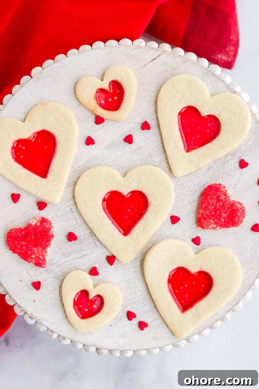 Stained Glass Cookies: Recipe and Decorating Tips 3 Heart shaped stained glass cookies with red melted candy in the middle