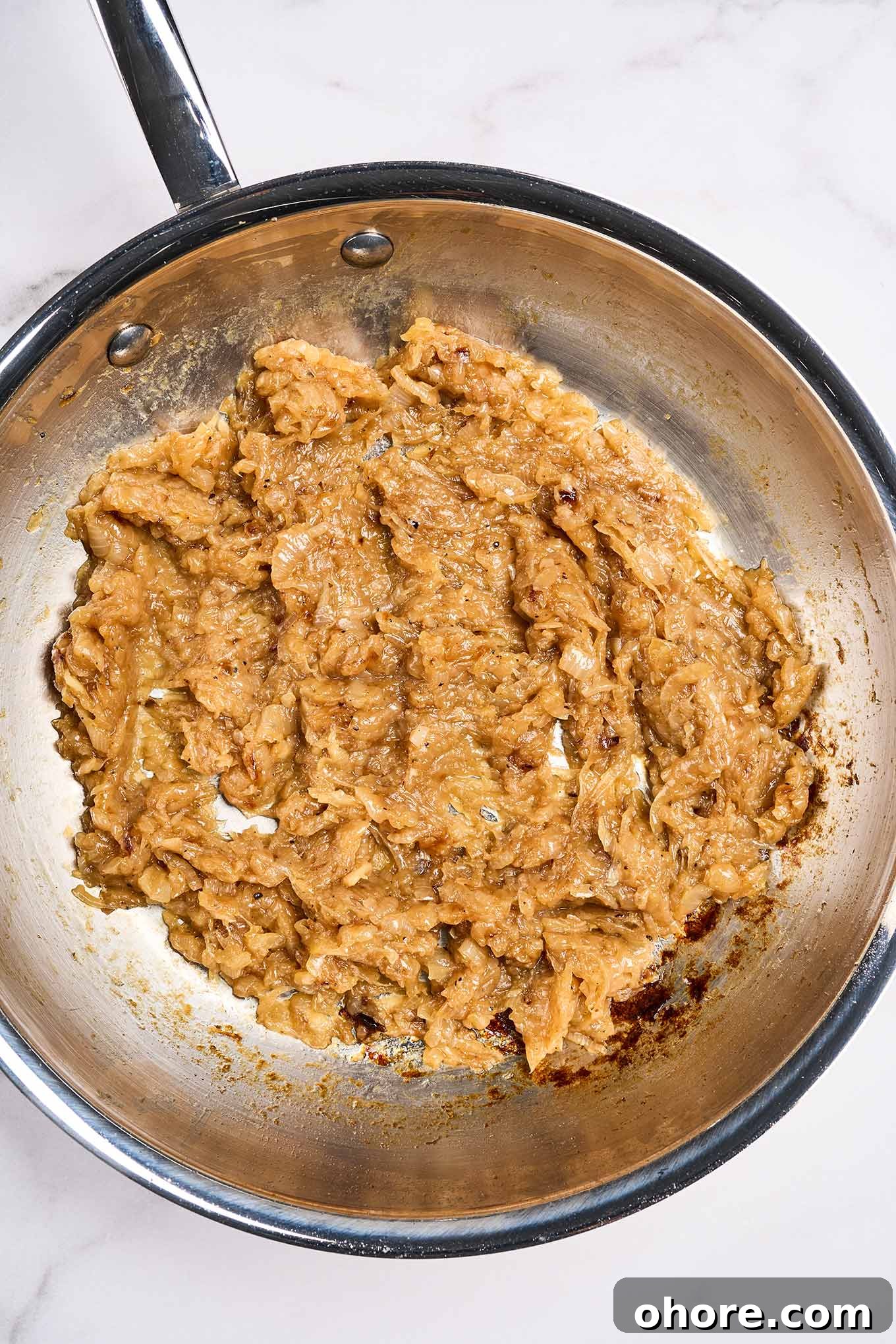 Perfect Caramelized Onions: Simple Step-by-Step Recipe 5 Fully caramelized onions in a stainless skillet, cooked down to a spreadable, jam-like consistency, 45 to 50 minutes.