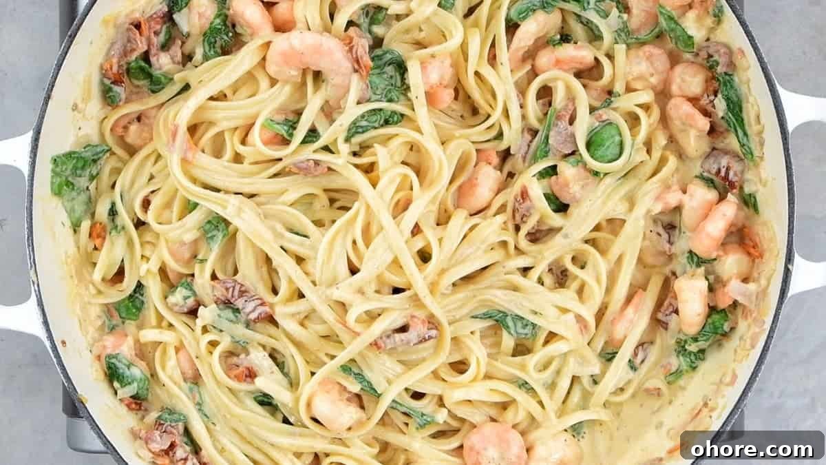 Add the linguine into the Tuscan shrimp