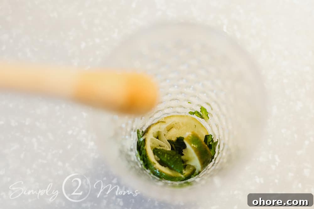 photo of muddled lime and mint for a mojito