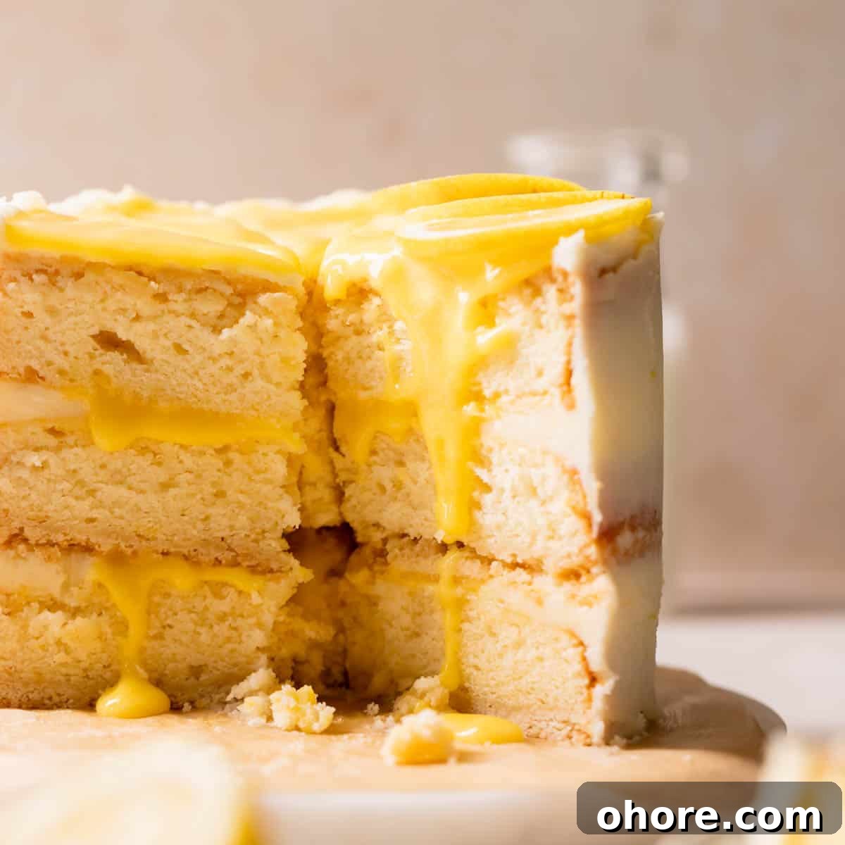 Zesty Lemon Bar Cake Recipe with Tender Shortbread Crust 15 lemon bar cake with lemon curd and fresh lemon slices.