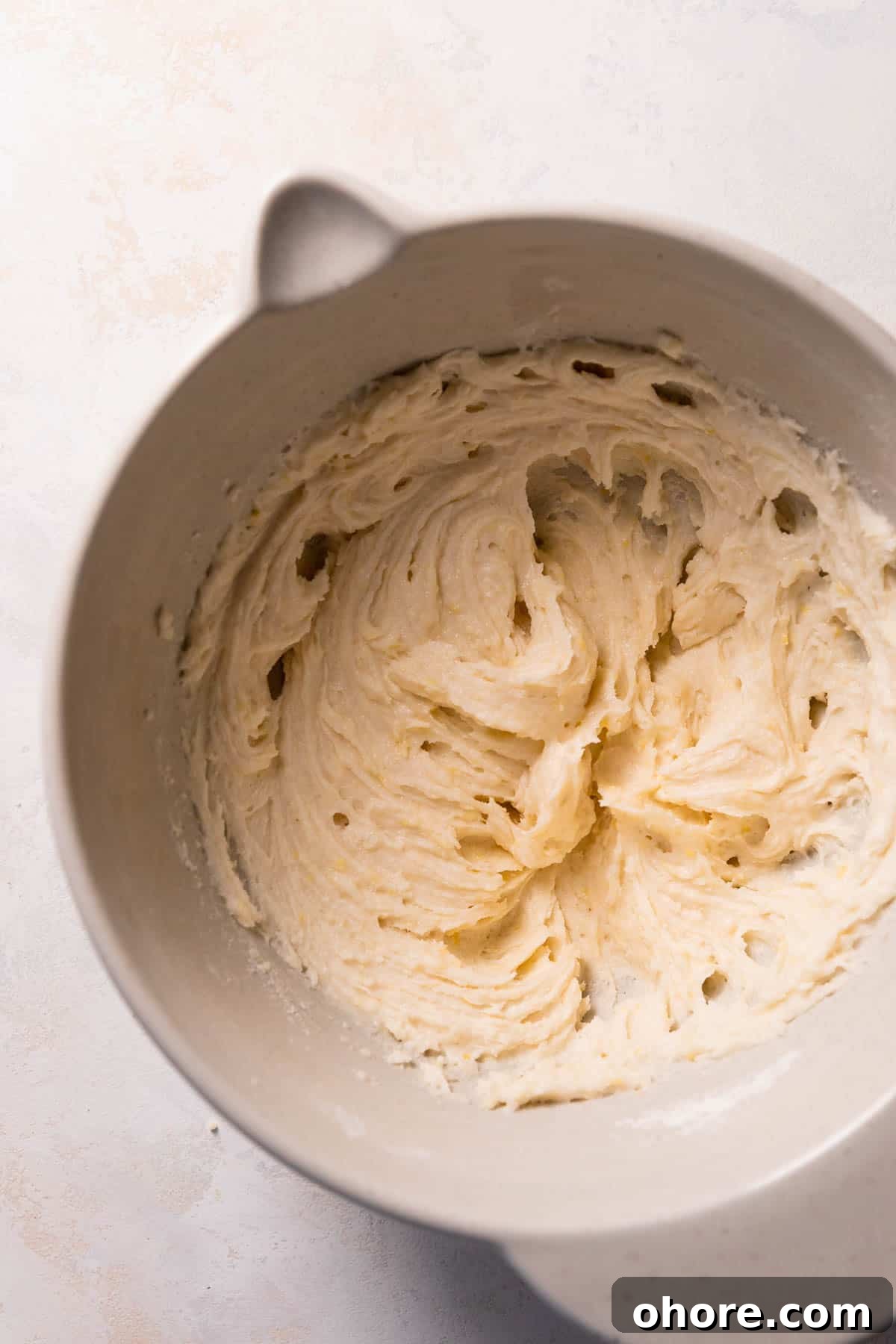 Zesty Lemon Bar Cake Recipe with Tender Shortbread Crust 8 lemon cake batter in a mixing bowl.