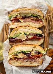 overhead shot of 3 sandwich halves in small basket showing filling
