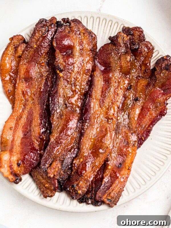 Decadent Double Chocolate Chip Muffins Recipe 11 Golden bacon slices on a white plate.