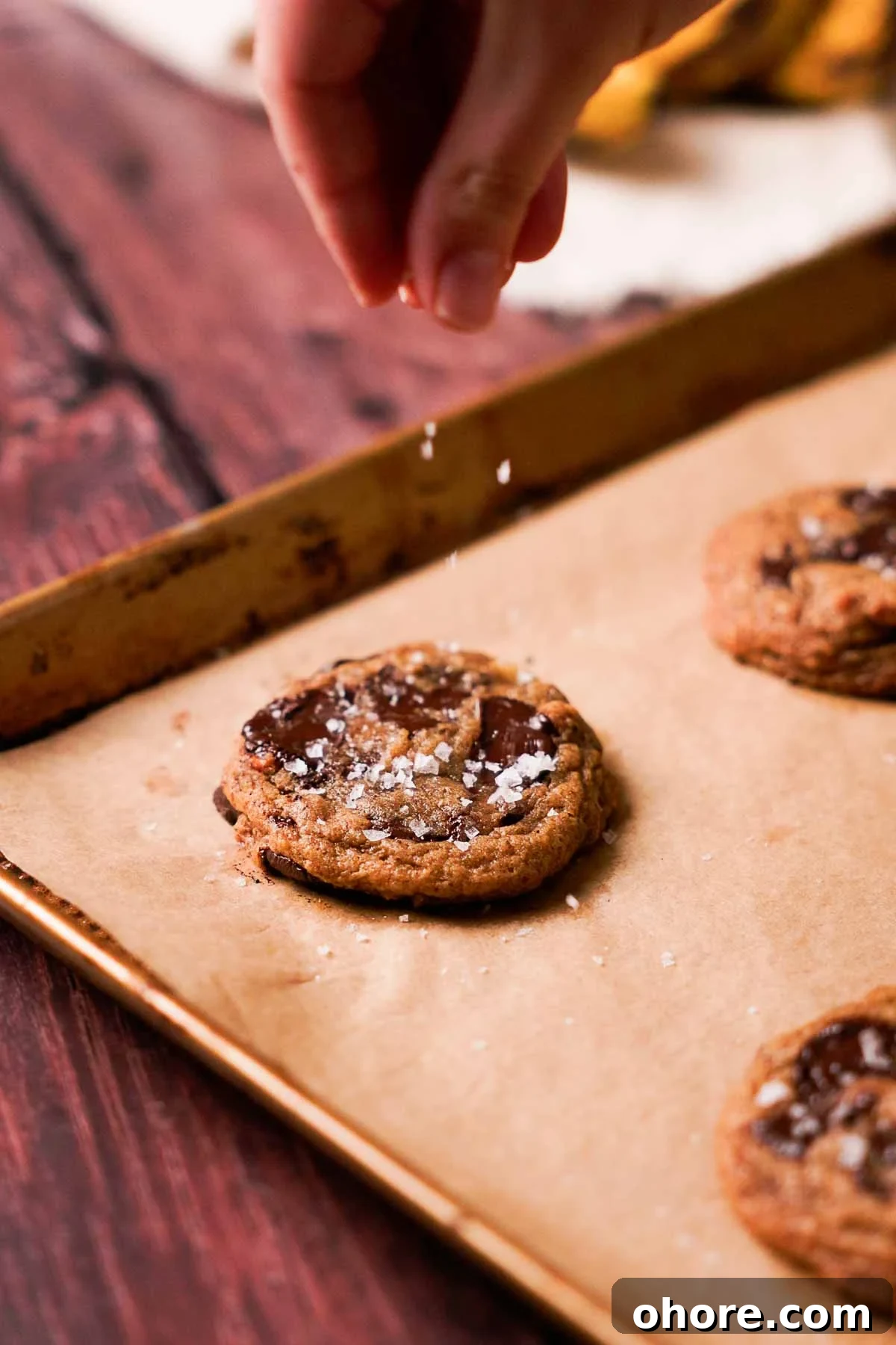 sprinkling salt on banana bread cookie