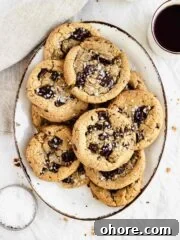 chocolate chip cookies on oval plate sprinkled with flaky salt