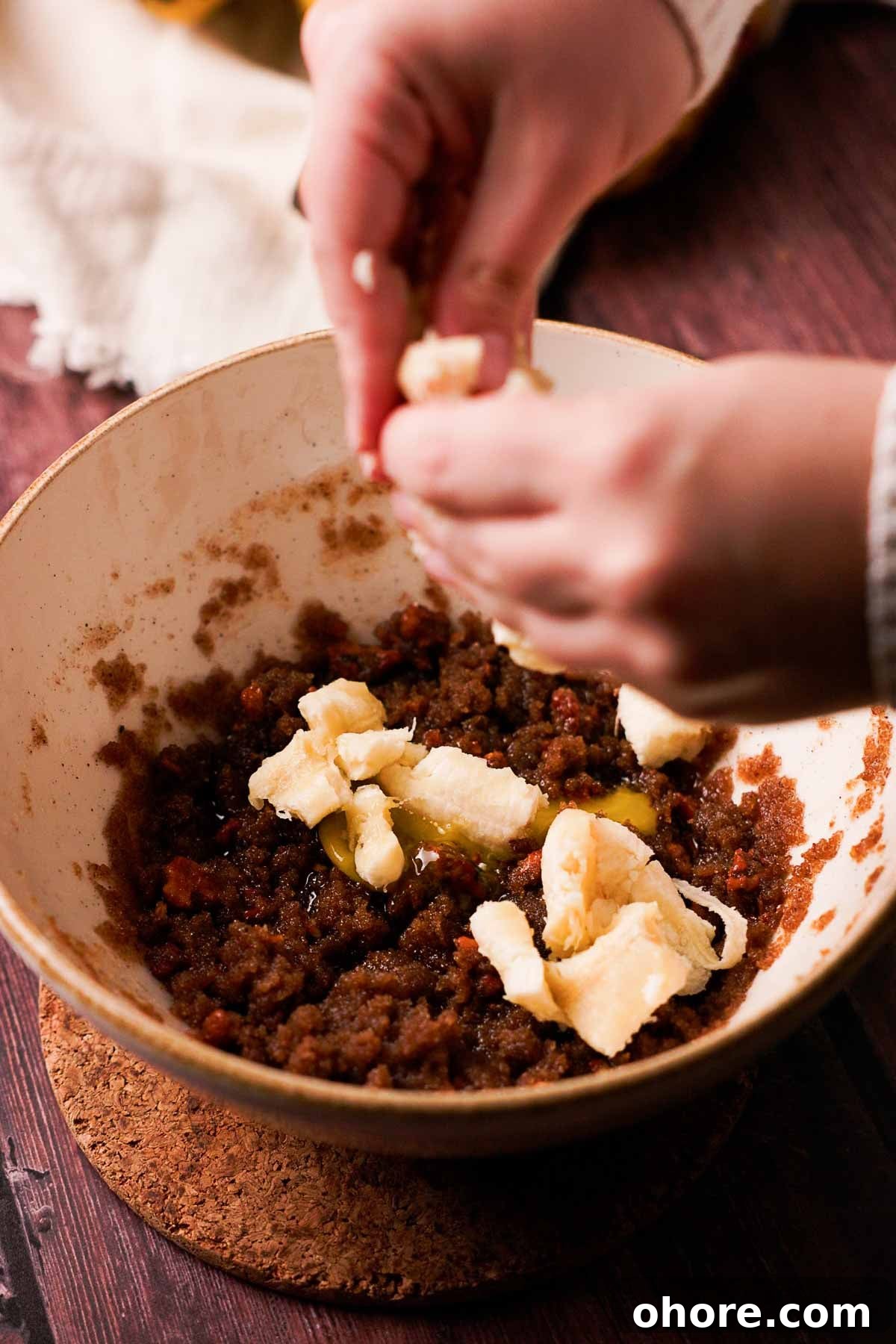 breaking up banana into pieces by hand