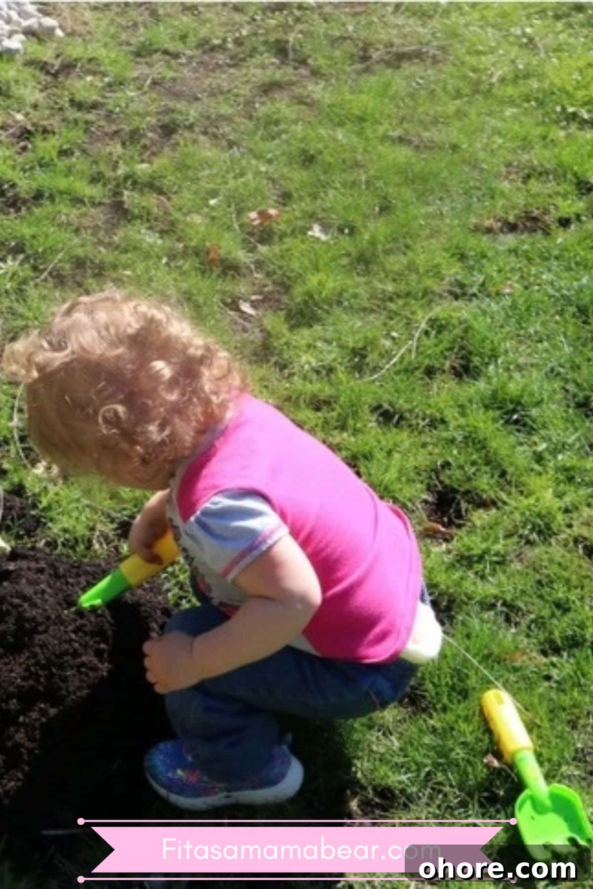 Toddler outside in the spring gardening