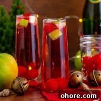 Sparkling Christmas Mocktail Recipes for Holiday Parties 4 Display of Christmas mocktail with champagne and fruit.