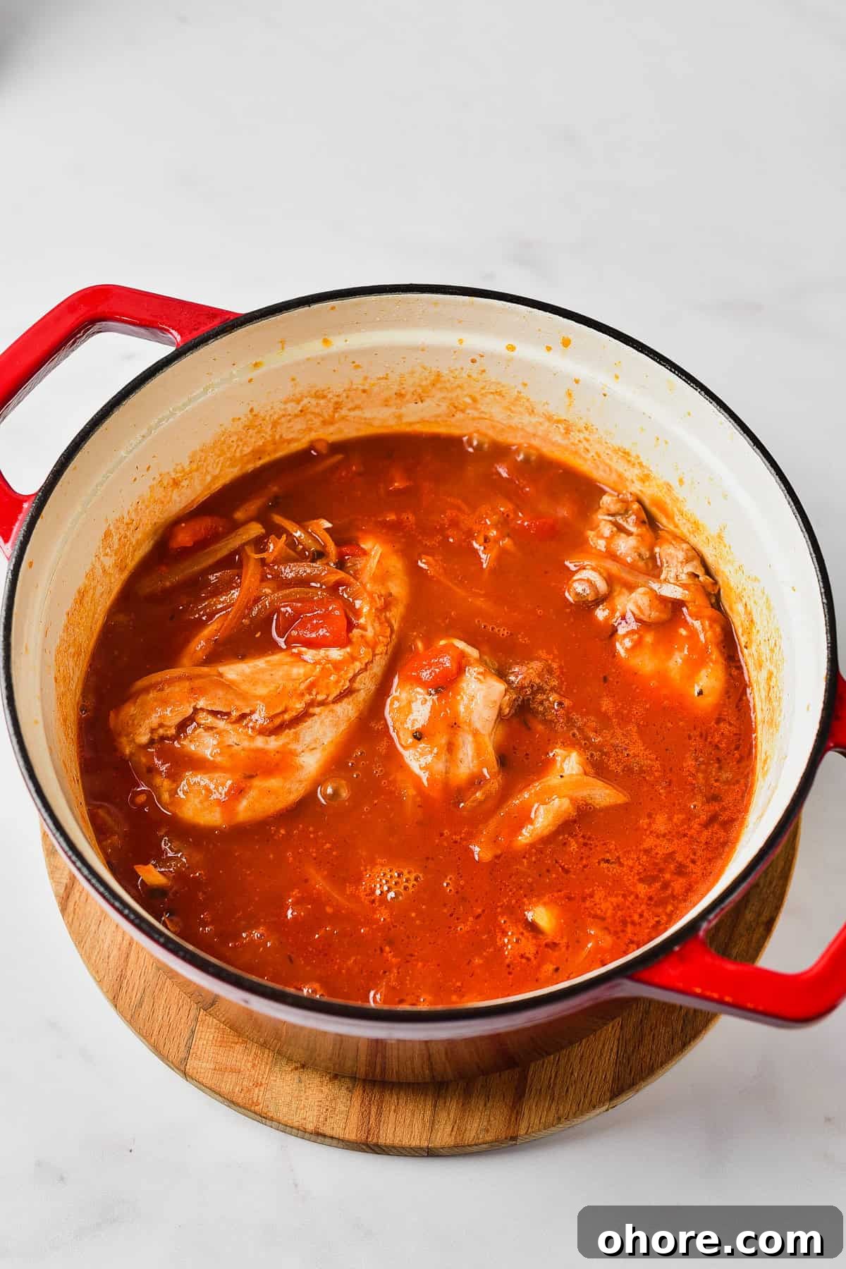 Authentic Chicken Tinga Recipe — Classic Tinga de Pollo 6 Cooking chicken in tanga suace.