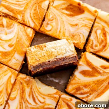 Sliced pumpkin cheesecake bars. One sits on its side.