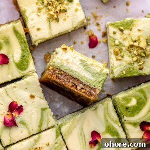 Sliced baklava cheesecake bars on parchment paper.