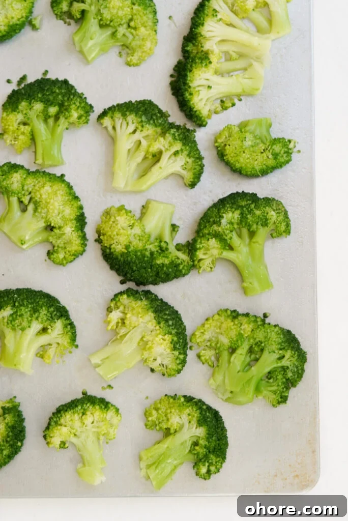 Crispy Smashed Broccoli with Parmesan and Garlic 8 overhead shot of smashed broccoli florets on a baking sheet.