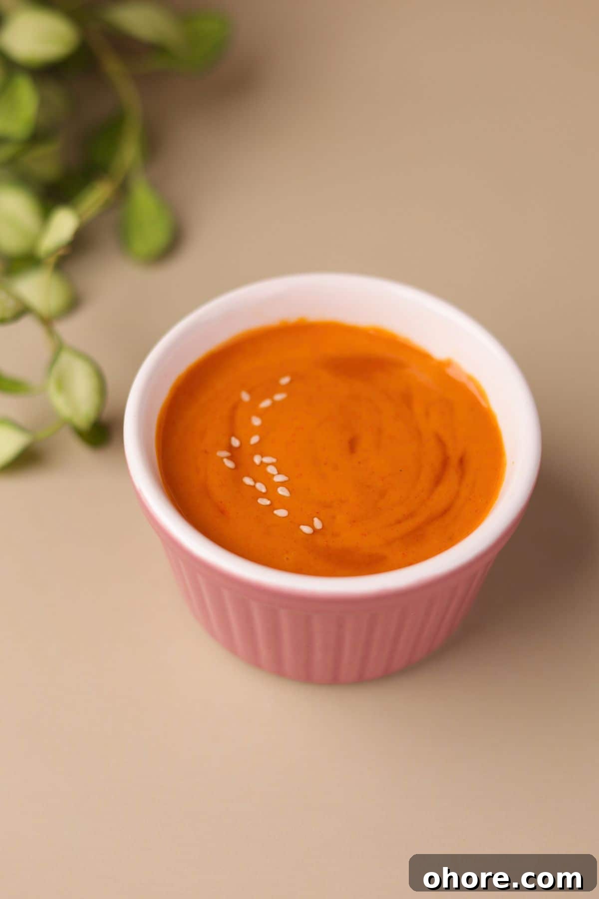 Vibrant looking Korean gochujang mayo in a glass bowl.