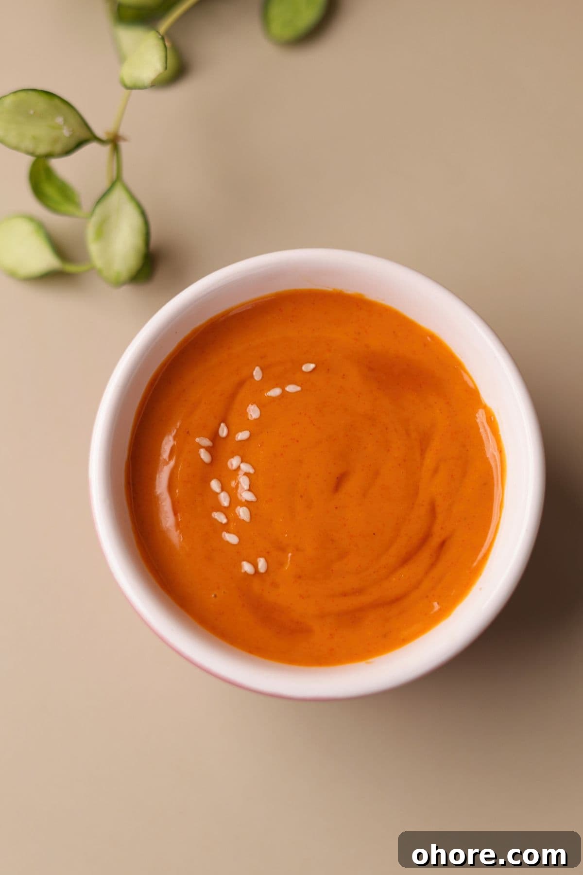 Spicy aioli with gochujang in a glass bowl.
