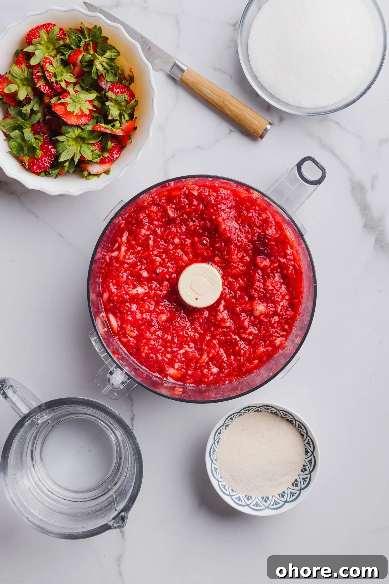 Fresh strawberries blended in a food processor.