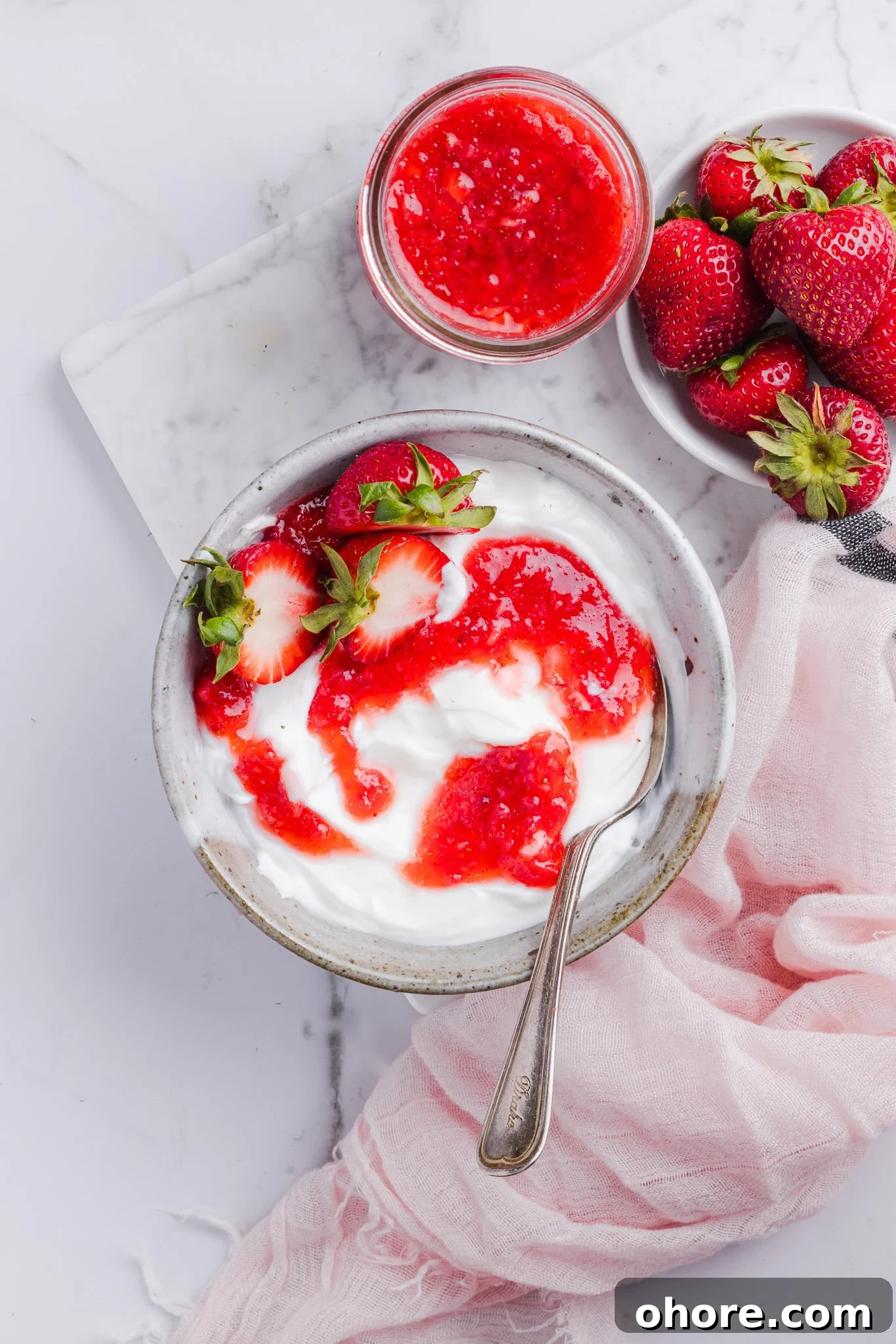 Low sugar strawberry freezer jam swirled into yogurt.