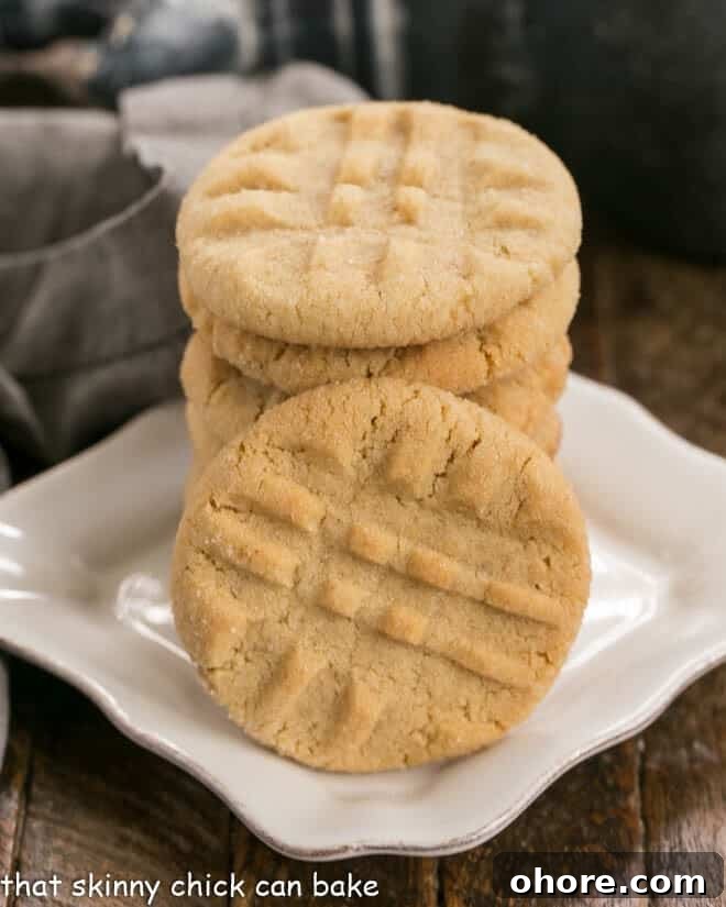 Best Peanut Butter Cookies - An exquisite easy peanut butter cookie recipe with the perfect snap and a bit of texture from extra chunky peanut butter! The Best Peanut Butter Cookies on a square white dessert plate.