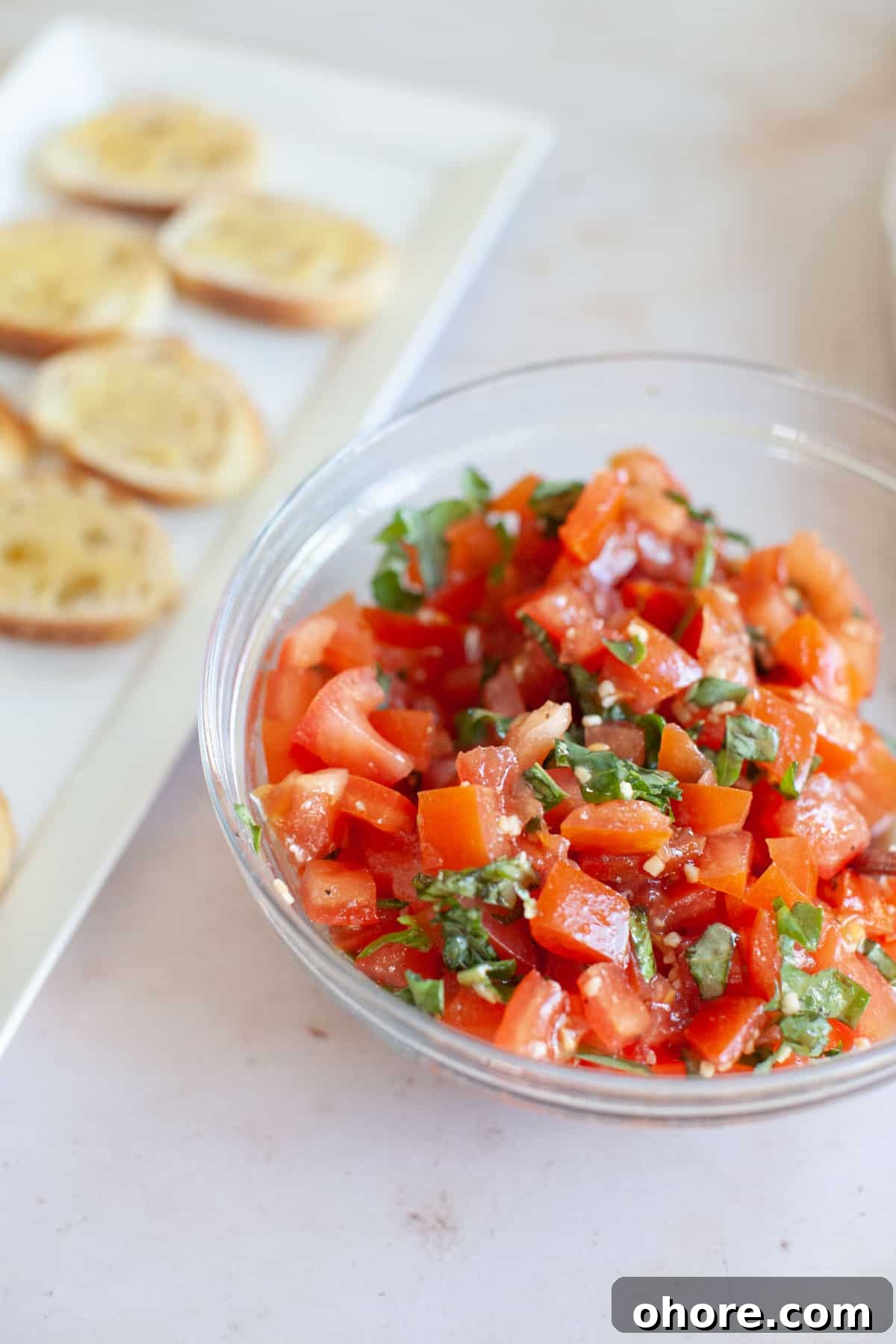 Bruschetta mix in a glass bowl.