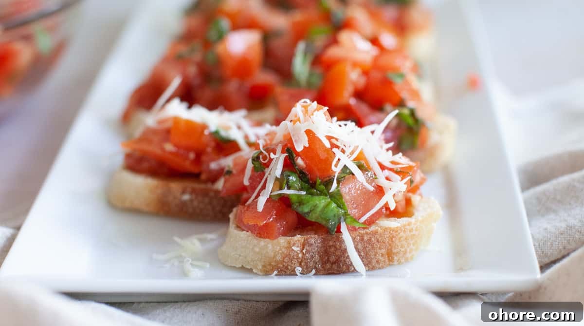 Close-up photo of pieces of bruschetta on a rectangular serving dish.