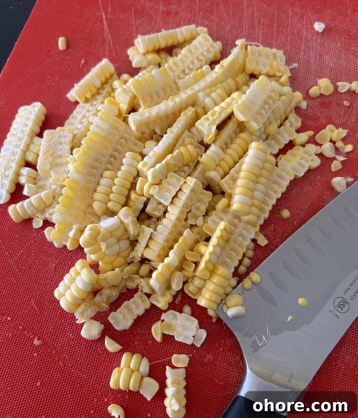 Cut up corn on the cob on cutting board.