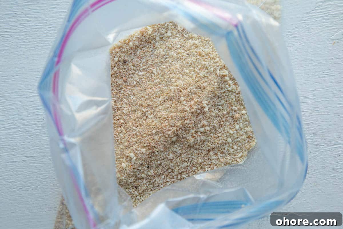 Crispy Parmesan-Crusted Baked Chicken Breast Recipe 4 plastic bag with a breadcrumb mixture inside.