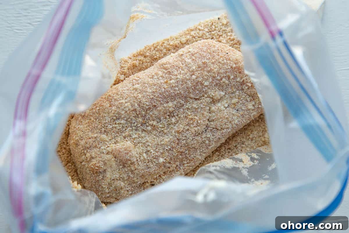 Crispy Parmesan-Crusted Baked Chicken Breast Recipe 6 breadcrumb coated chicken breast in a large plastic bag.