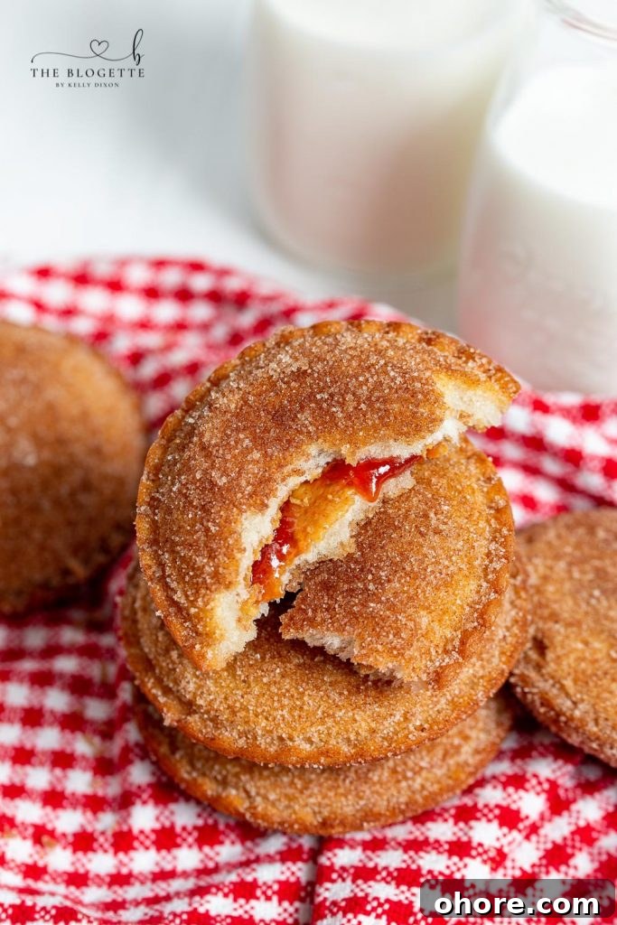 Uncrustable Donuts: Bite-Sized Filled Donut Recipe 3 Uncrustable Donuts with peanut butter and jelly inside.