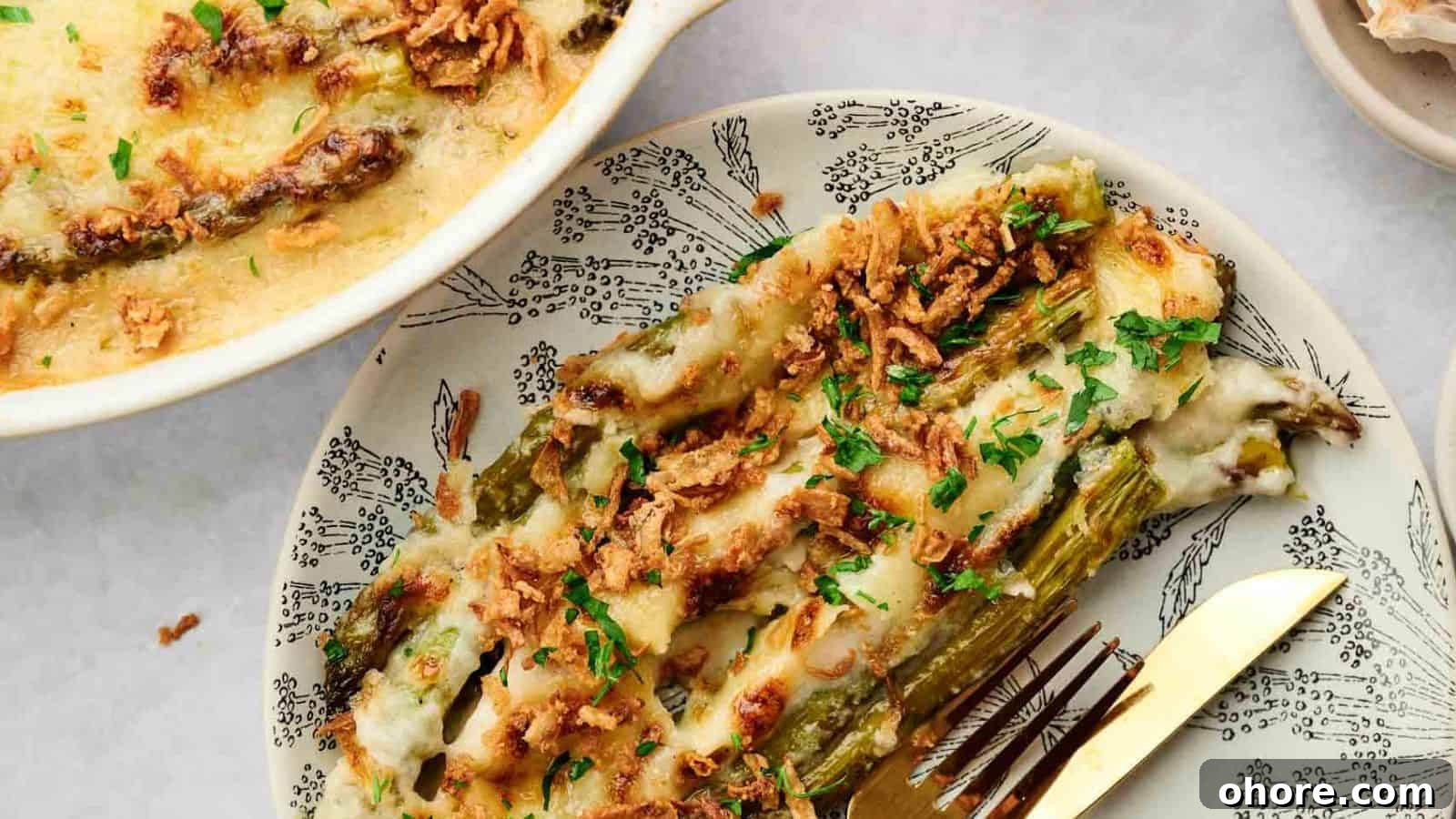 29 Cozy Air Fryer Casseroles for Warm January Dinners 16 Cheesy asparagus casserole on a plate with a fork.