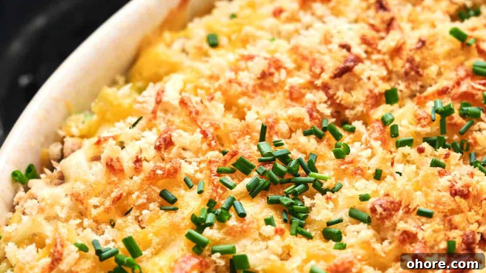 29 Cozy Air Fryer Casseroles for Warm January Dinners 29 A close-up of a baked dish topped with golden bread crumbs and chopped chives.