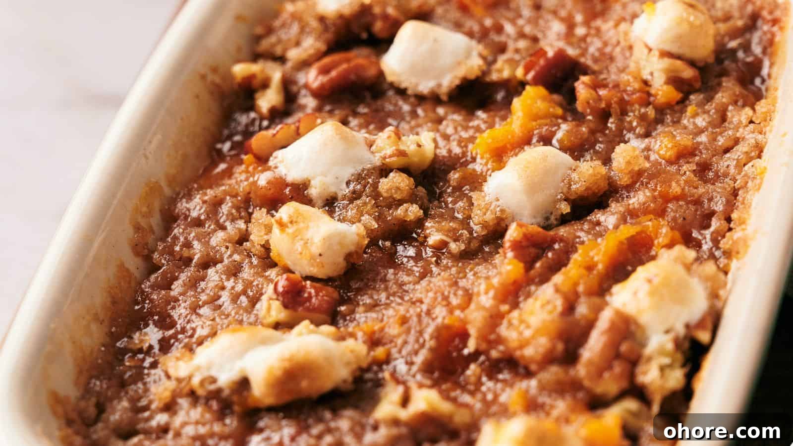 29 Cozy Air Fryer Casseroles for Warm January Dinners 8 A white dish with a sweet potato casserole on top of a wooden cutting board.