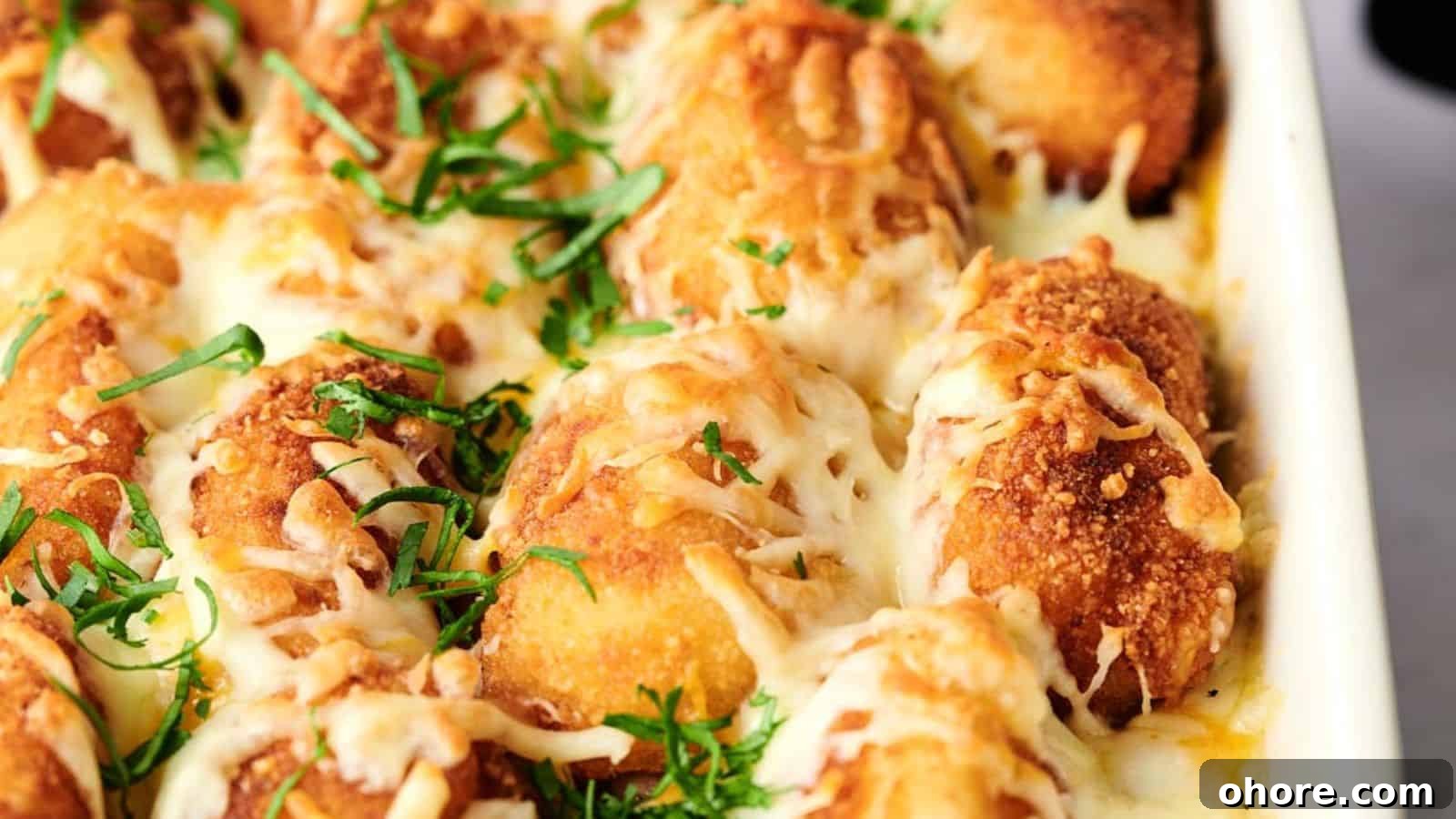 29 Cozy Air Fryer Casseroles for Warm January Dinners 9 A close-up of a baking dish filled with breaded, cheese-covered chicken pieces garnished with chopped herbs, reminiscent of an elevated air fryer tater tot casserole.