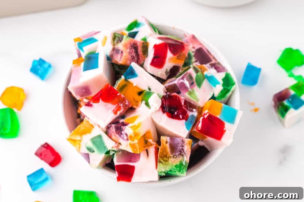 Retro Broken Glass Jello Recipe – Colorful Layered Dessert 4 Broken Glass Jello dessert cubes served in a bowl with colorful stained glass gelatin pieces