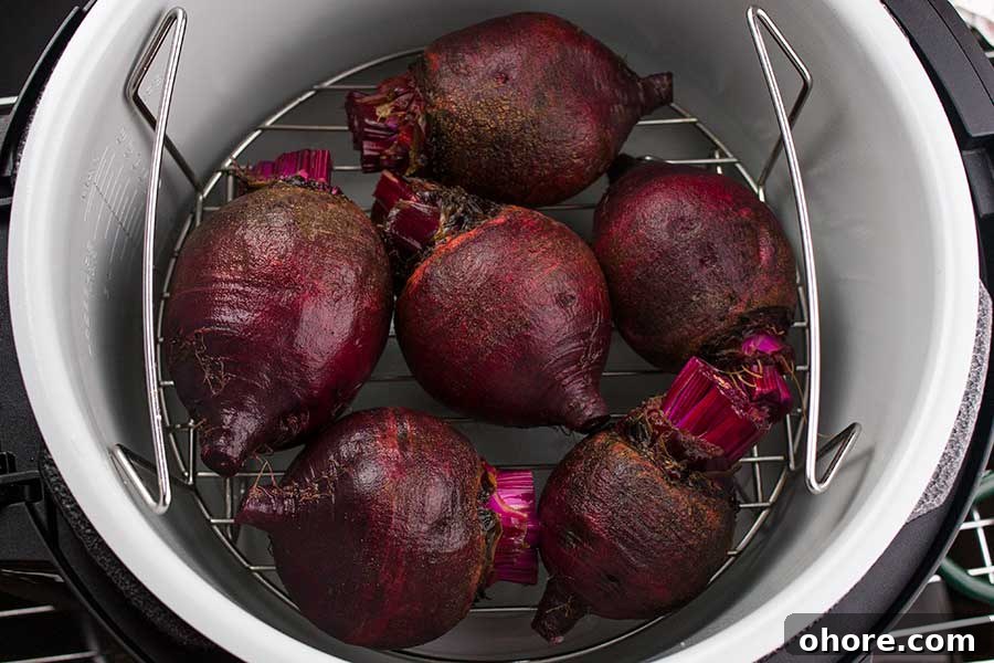 Ninja Foodi Pressure Cooker Fresh Beets - Fresh beets in 30 minutes! So flavorful, tender and healthy! A beautiful colorful side dish to any meal. Raw beets with greens removed on the lower rack in the Ninja Foodi pot.