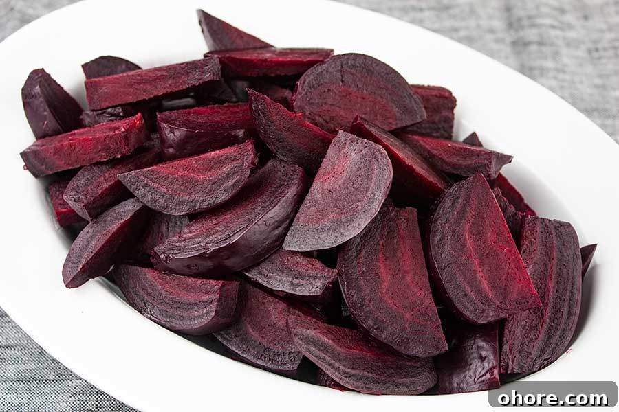 Ninja Foodi Pressure Cooker Fresh Beets - Fresh beets in 30 minutes! So flavorful, tender and healthy! A beautiful colorful side dish to any meal. Pressure cooker beets sliced and piled in a white platter.