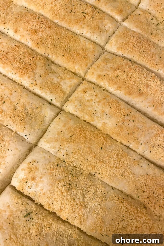 Parmesan Garlic Breadsticks: Homemade Recipe in 30 Minutes 4 Quick and easy homemade breasticks on a sheet pan cut into individual breadsticks