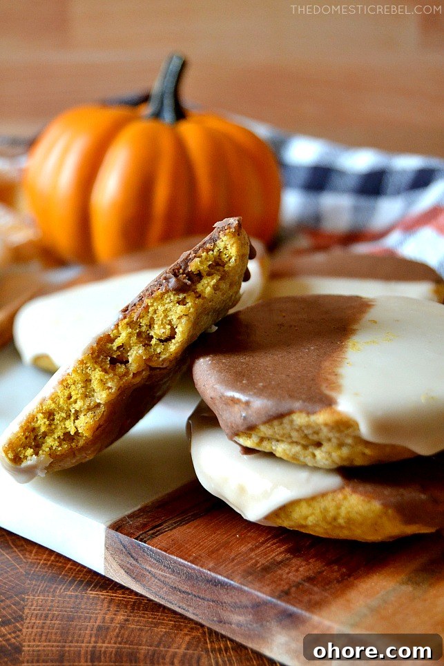 Small stack and arrangement of pumpkin black and white cookies with a pumpkin
