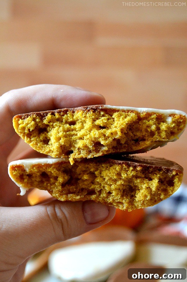 Closeup of author holding a split open pumpkin black and white cookie