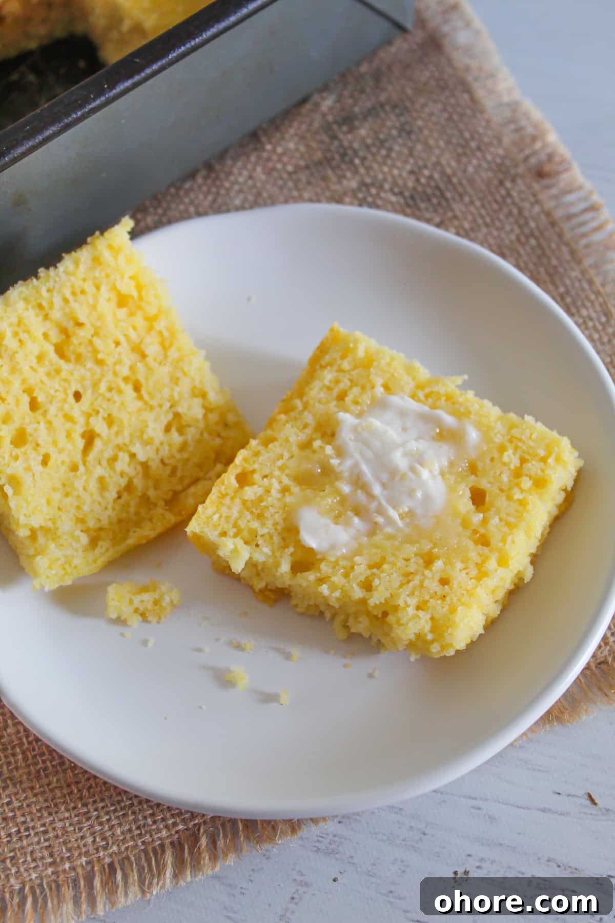 Almond Flour Cornbread: Dairy-Free, Gluten-Free Recipe 12 gluten-free cornbread sliced in half with butter inside.