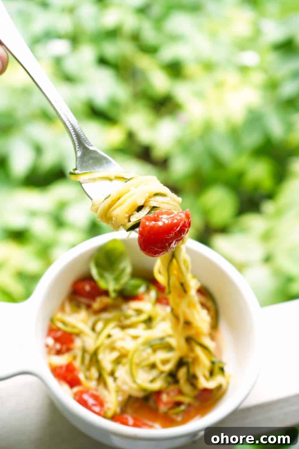 zucchini noodles on fork with tomato zucchini noodles on fork with tomato