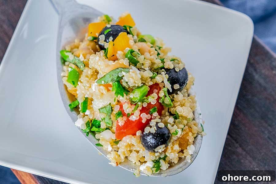 32 Gluten-Free Recipes That Support Weight Loss Goals 11 Greek quinoa salad on a spoon