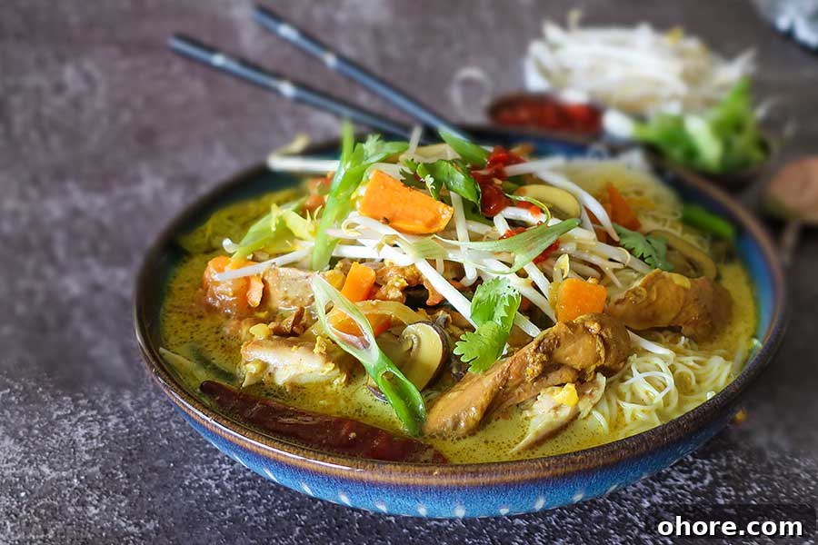 32 Gluten-Free Recipes That Support Weight Loss Goals 21 Malaysian soup with veggies and noodles in a bowl