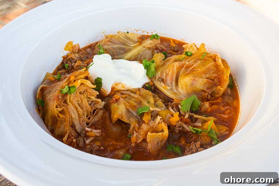 32 Gluten-Free Recipes That Support Weight Loss Goals 22 cabbage roll soup in a bowl topped with sour cream