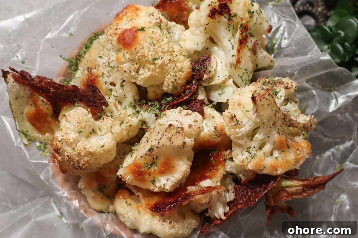 32 Gluten-Free Recipes That Support Weight Loss Goals 32 golden brown pieces of cauliflower with melted cheese on parchment
