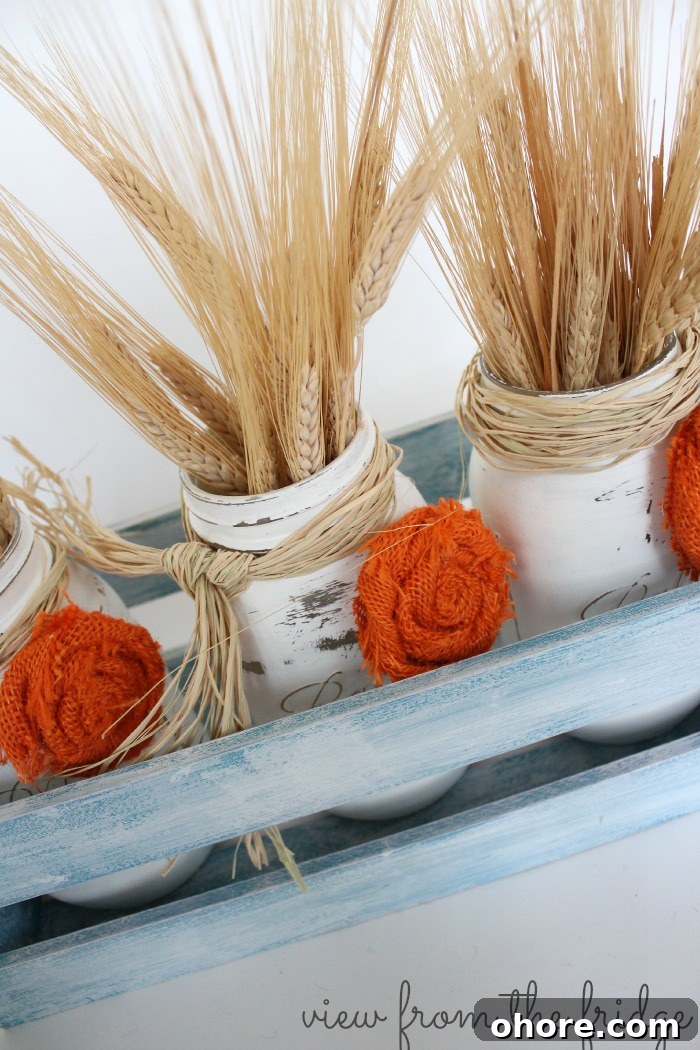 Easy fall DIY decor idea ... distressed mason jars and burlap rosettes