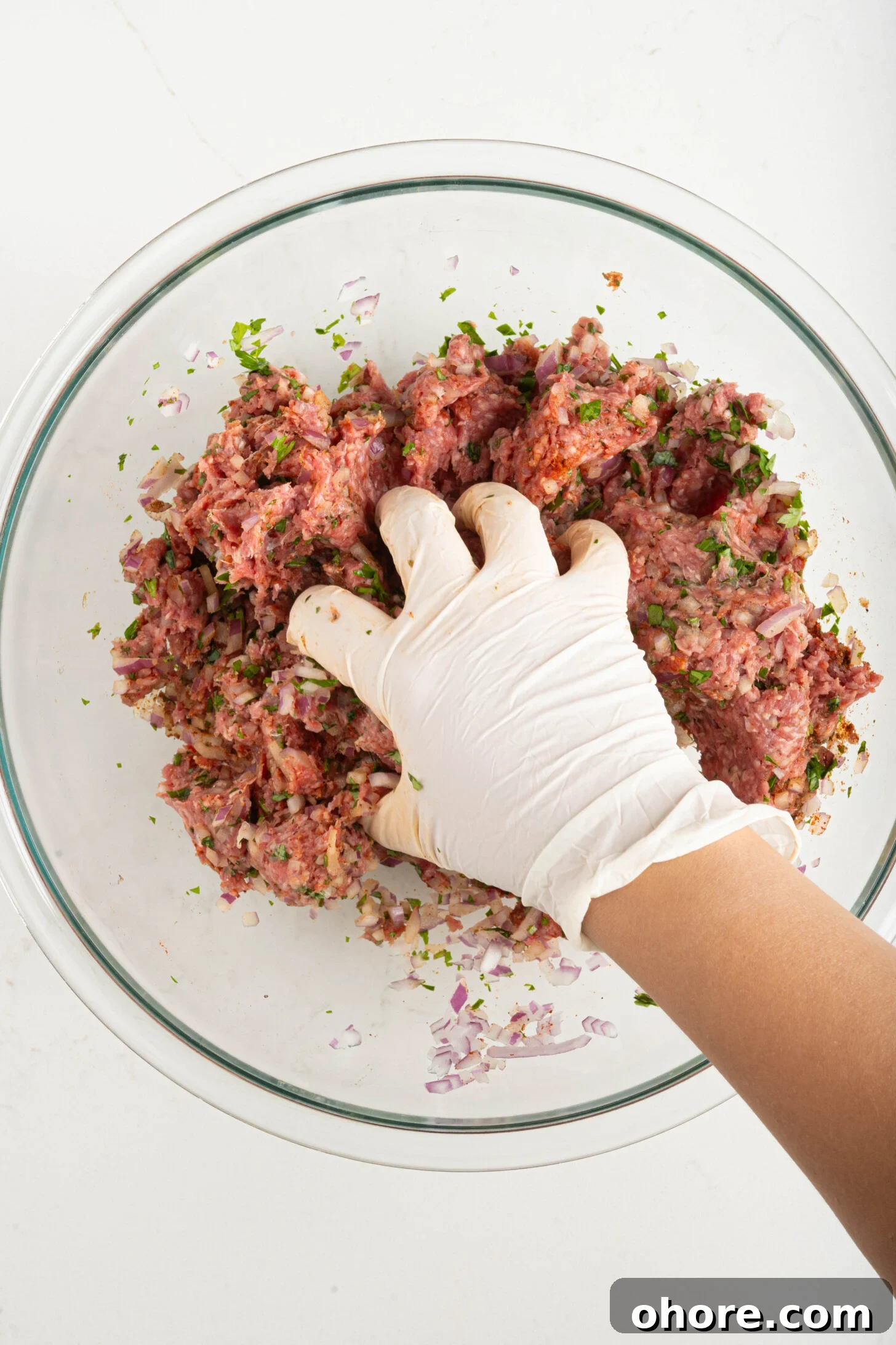 30-Minute Moroccan Kefta Brochettes Recipe — Grilled Lamb Skewers 4 a hand mixing kefta meat
