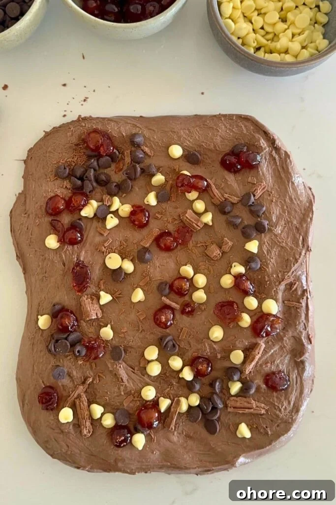 Sourdough Recipes for a Romantic Valentine’s Day Meal 39 A rectangle of chocolate sourdough decorated with white and semi sweet chocolate chips and glace cherries.