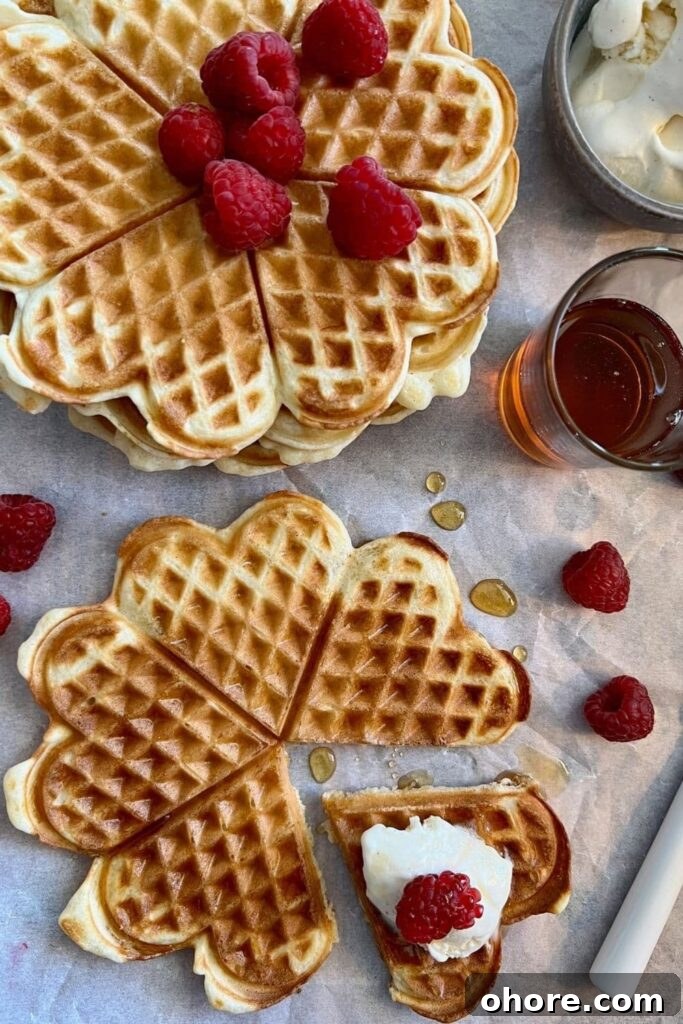 Sourdough Recipes for a Romantic Valentine’s Day Meal 6 Heart shaped sourdough waffles decorated with raspberries and cream for Valentine's Day.