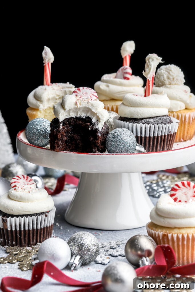 Refreshing Peppermint Cupcakes Recipe with Creamy Frosting 2 peppermint cupcakes on a small cake tray with a bite taken out of the chocolate one
