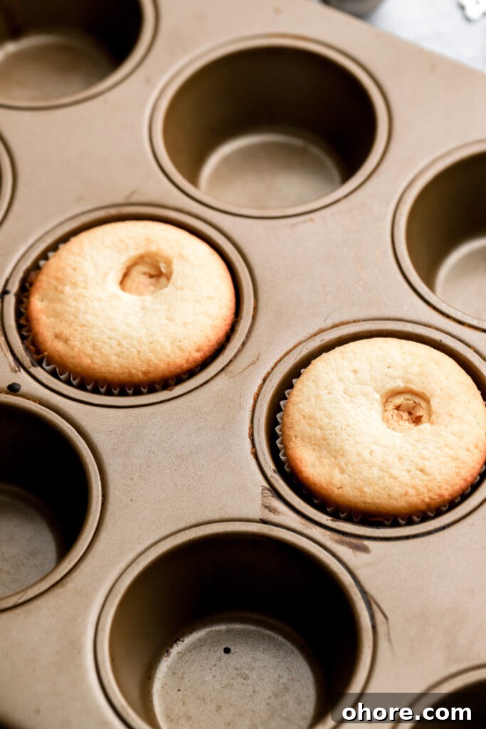Refreshing Peppermint Cupcakes Recipe with Creamy Frosting 12 white cupcakes with truffle baked inside
